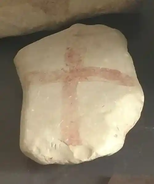 Painted pebbles limestone, pre-Christian cross on a stone